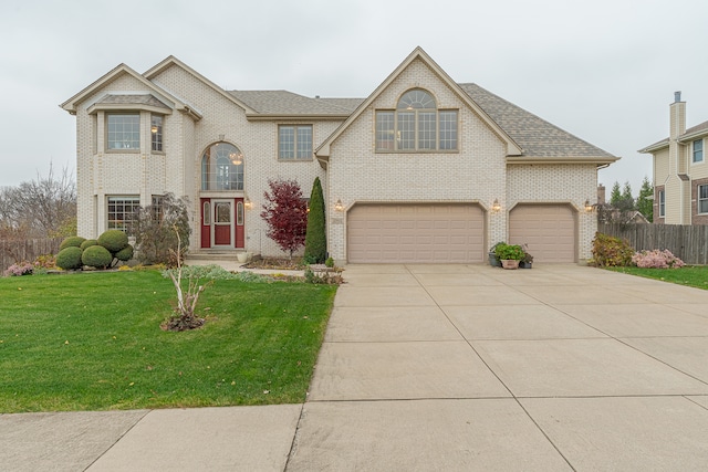 view of front of property with a garage and a front yard