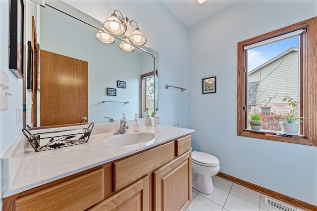 bathroom with tile patterned flooring, vanity, and toilet