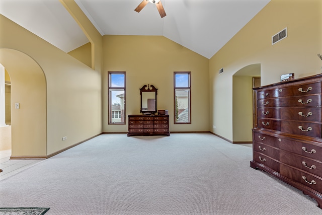 bedroom with ceiling fan, light carpet, and high vaulted ceiling