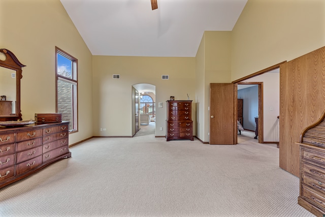 bedroom featuring ceiling fan, light carpet, high vaulted ceiling, and multiple windows