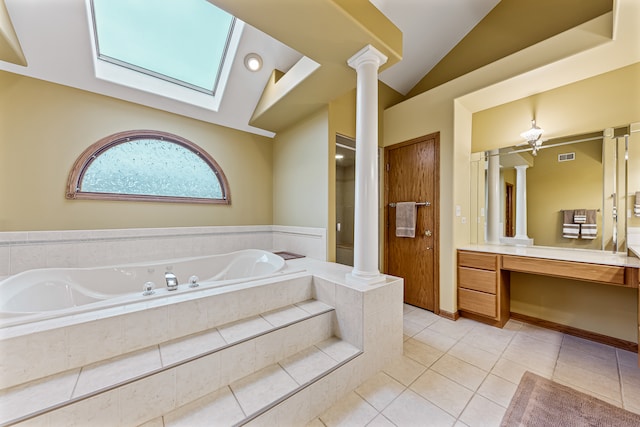 bathroom with tile patterned floors, tiled tub, vanity, and vaulted ceiling