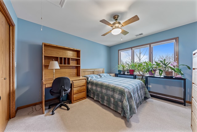 carpeted bedroom featuring a closet and ceiling fan