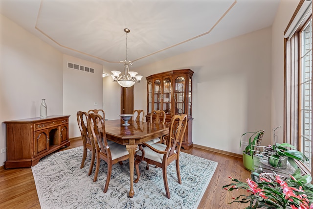 dining room with a chandelier and light hardwood / wood-style floors