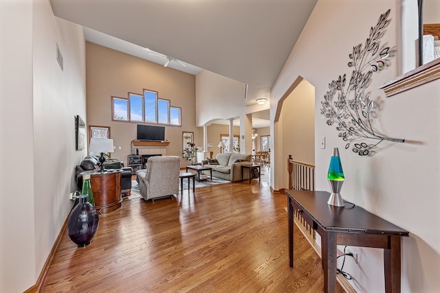 interior space featuring hardwood / wood-style floors and a high ceiling