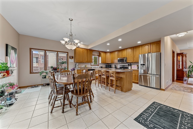 dining room with light tile patterned flooring and a notable chandelier