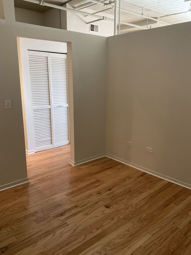 empty room with hardwood / wood-style floors