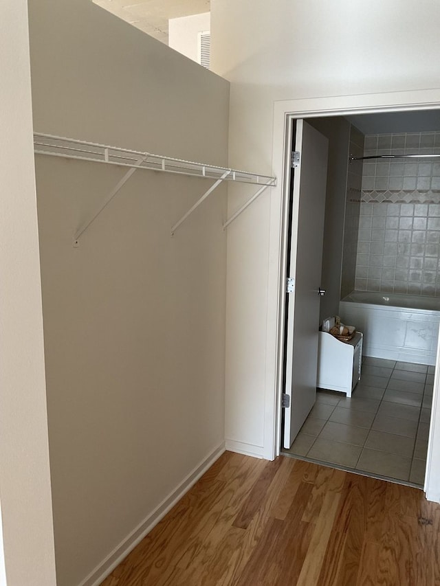 clothes washing area with hardwood / wood-style flooring