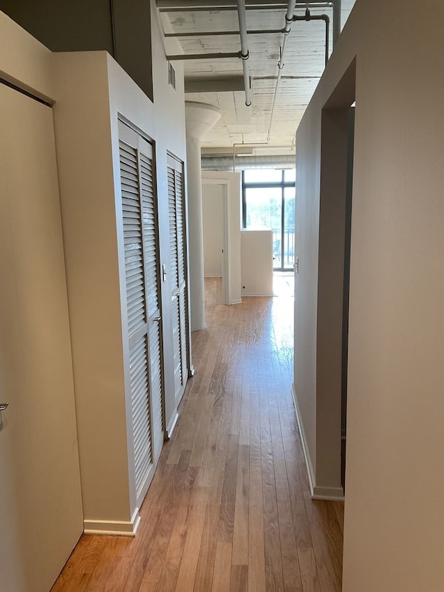 corridor with light hardwood / wood-style flooring