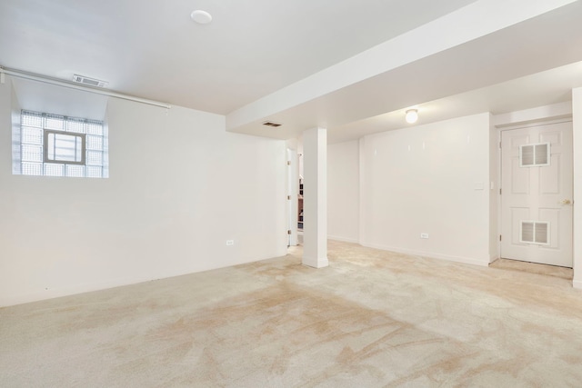 basement featuring light carpet