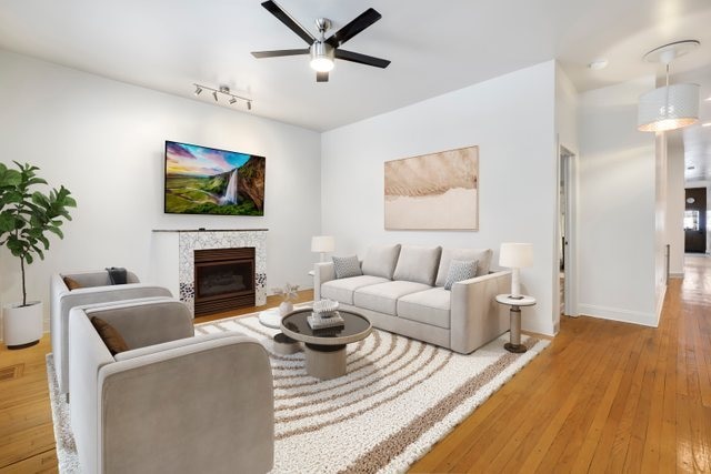 unfurnished living room featuring light hardwood / wood-style flooring and ceiling fan