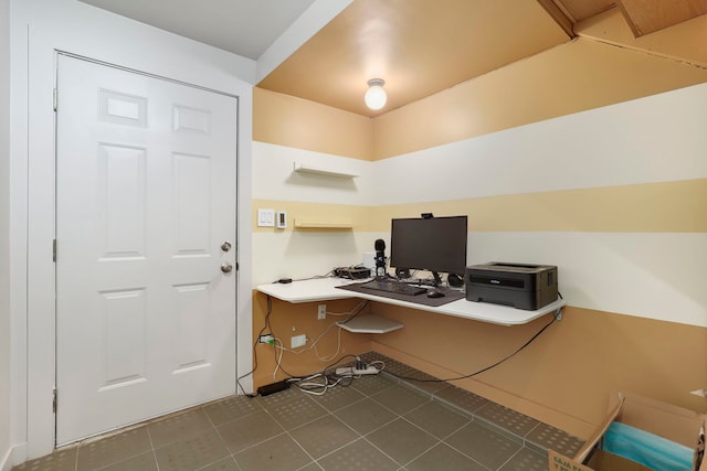 office area featuring dark tile patterned flooring