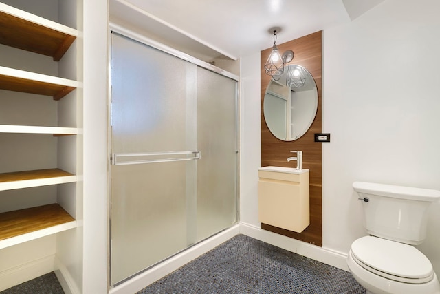 bathroom with sink, an enclosed shower, and toilet