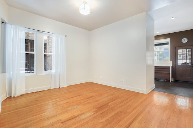 unfurnished room with light hardwood / wood-style flooring