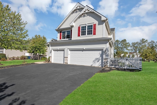 view of front facade with a garage and a front yard