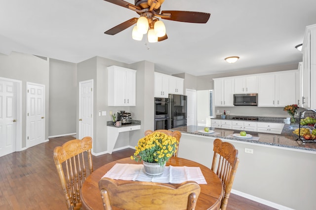 dining space with dark wood-type flooring and ceiling fan