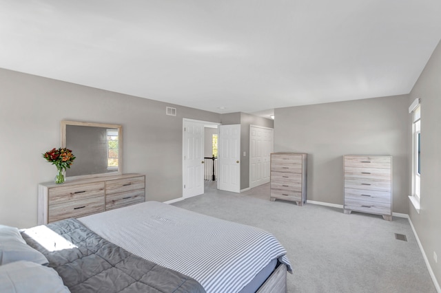 bedroom featuring light colored carpet