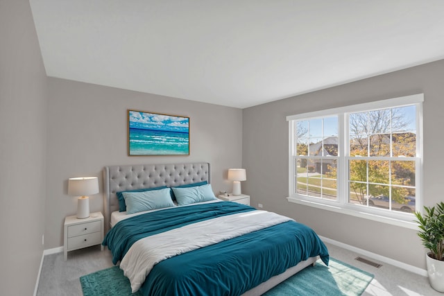 bedroom featuring light carpet