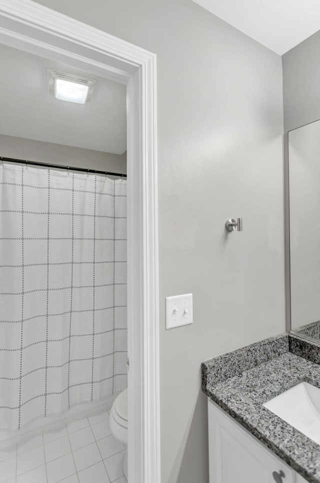 bathroom featuring vanity, tile patterned flooring, toilet, and a shower with curtain