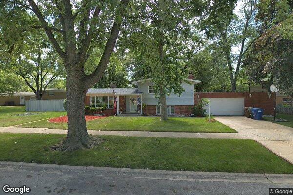 tri-level home with a front yard and a garage