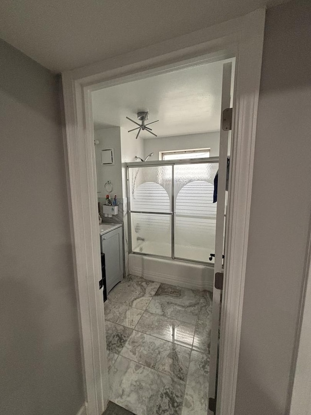 bathroom with shower / bath combination with glass door and vanity