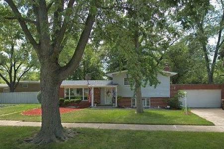 tri-level home with a front yard and a garage