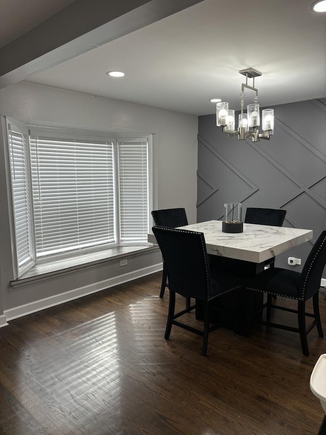 dining area featuring dark hardwood / wood-style floors and a notable chandelier