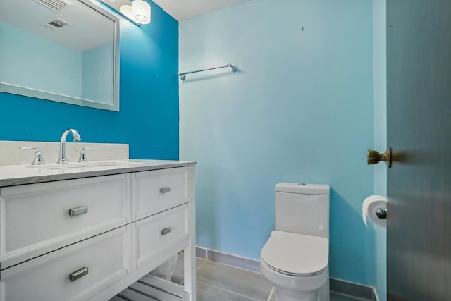 bathroom with toilet and vanity