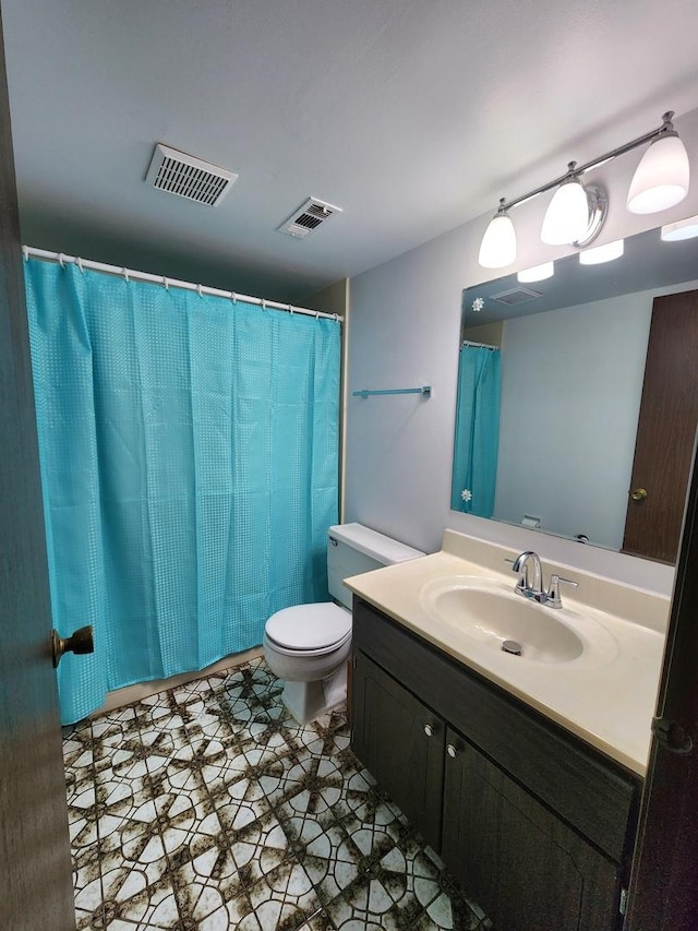 bathroom featuring toilet and vanity