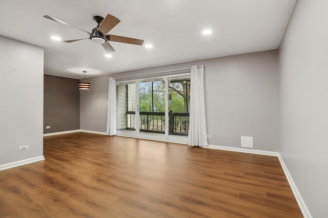 unfurnished room with ceiling fan and hardwood / wood-style floors