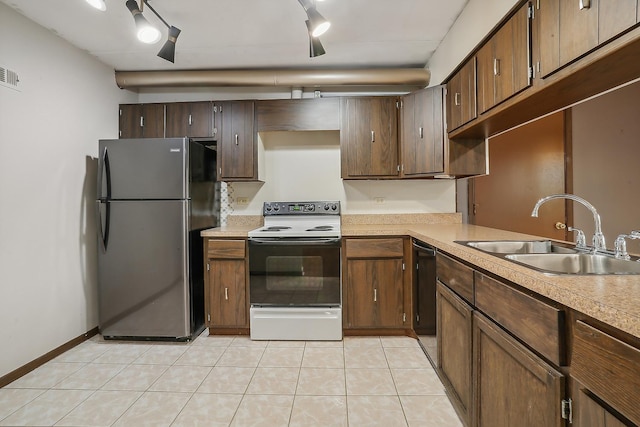 kitchen featuring refrigerator, white range with electric stovetop, sink, light tile patterned floors, and rail lighting