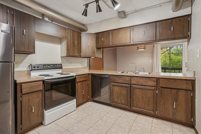 kitchen featuring appliances with stainless steel finishes, dark brown cabinetry, and sink