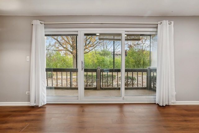 doorway to outside with dark wood-type flooring