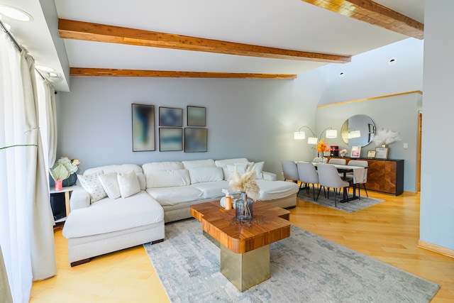 living room with hardwood / wood-style flooring and lofted ceiling with beams