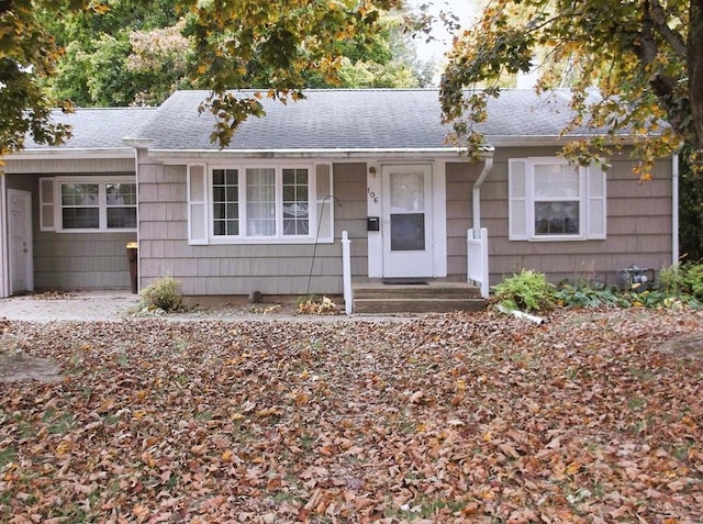 single story home with a shingled roof