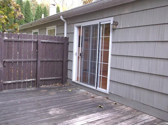 wooden terrace featuring fence