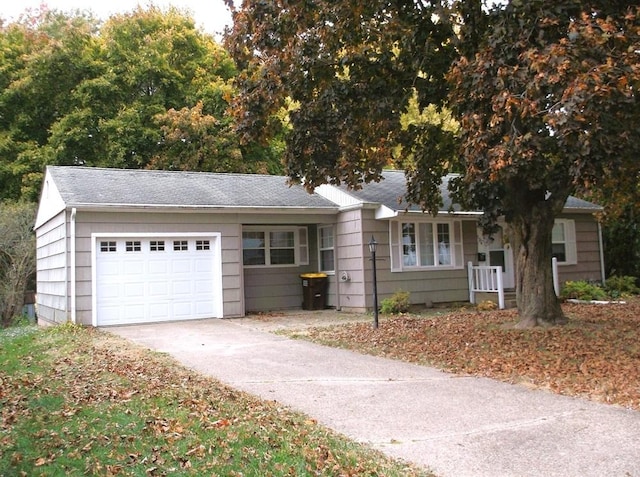 ranch-style home with a garage and concrete driveway