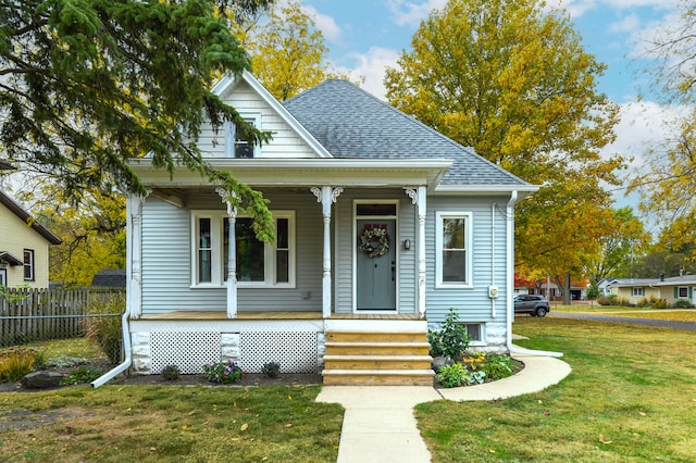 bungalow featuring a front yard and covered porch