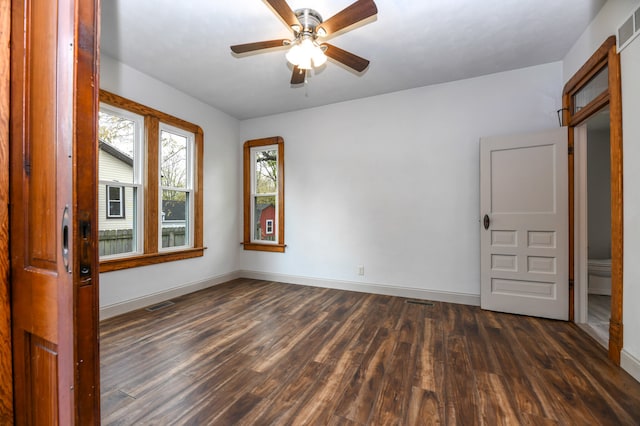 unfurnished room featuring dark wood-type flooring and ceiling fan