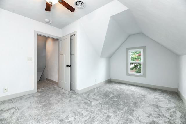 bonus room featuring light carpet, ceiling fan, and vaulted ceiling