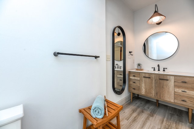 bathroom featuring hardwood / wood-style floors, vanity, and toilet