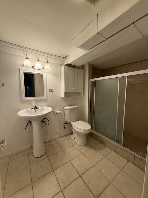 bathroom with toilet, sink, tile patterned floors, and a shower with door