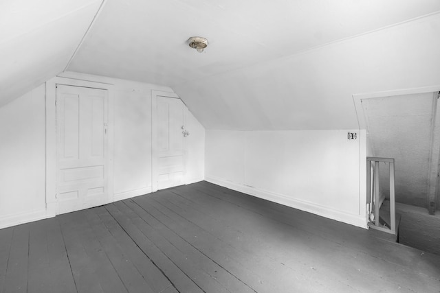 bonus room featuring dark wood-type flooring and lofted ceiling