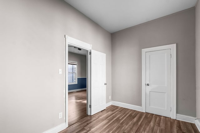 unfurnished bedroom featuring dark hardwood / wood-style flooring