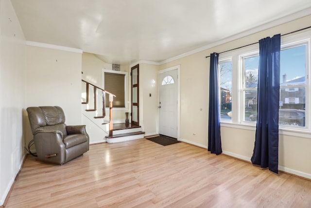 entryway featuring light hardwood / wood-style flooring and ornamental molding