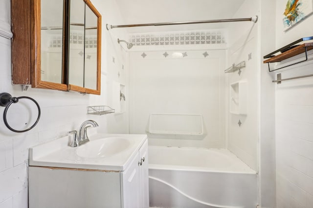 bathroom with vanity and tiled shower / bath combo