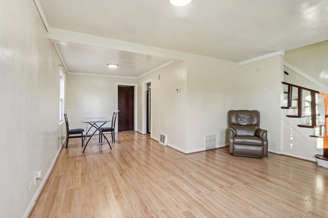 sitting room with light hardwood / wood-style flooring and ornamental molding