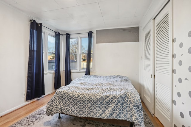 bedroom with hardwood / wood-style floors and a closet