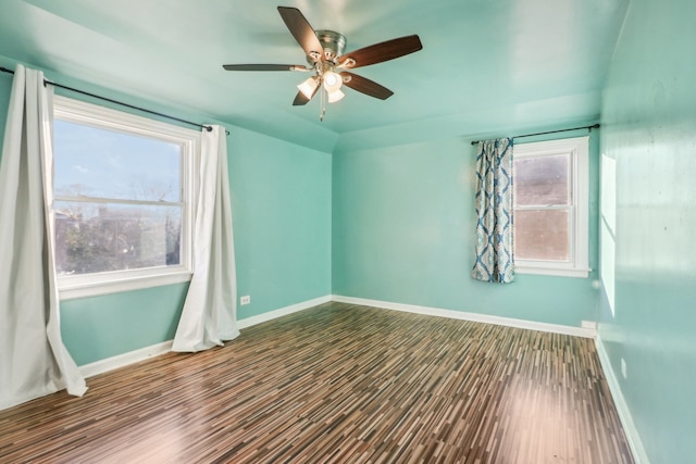 unfurnished room featuring ceiling fan, plenty of natural light, and wood-type flooring