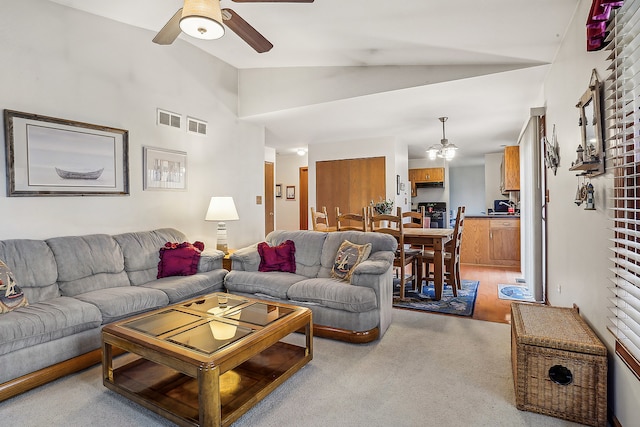 living room with light carpet, vaulted ceiling, and ceiling fan