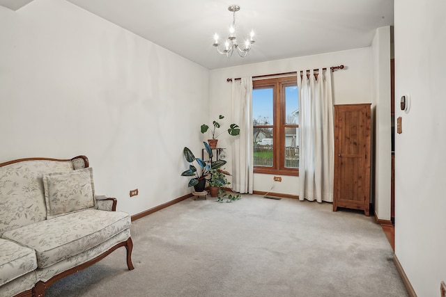 sitting room with light carpet and a notable chandelier